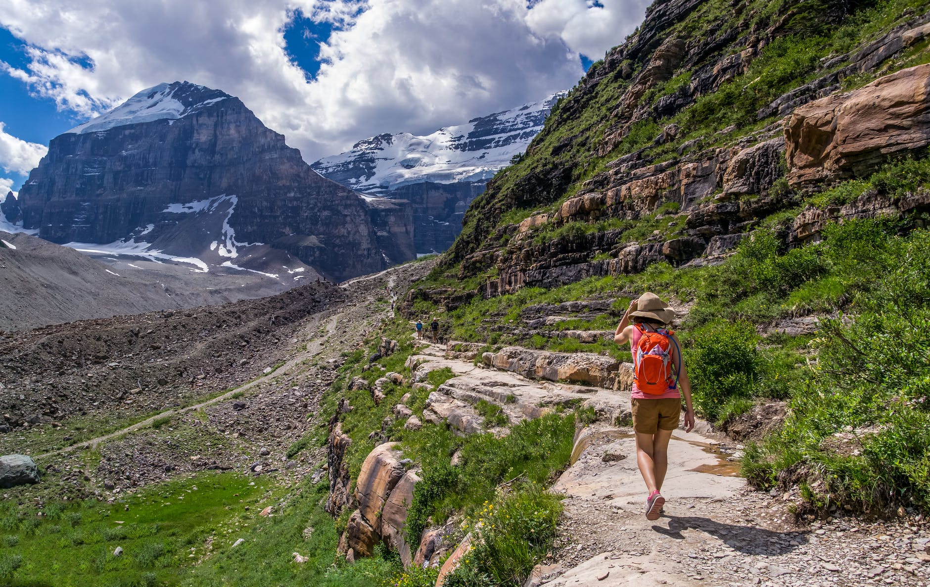 A person walking along a path in the mountains - get tips for adventure travel for women from Wanderful