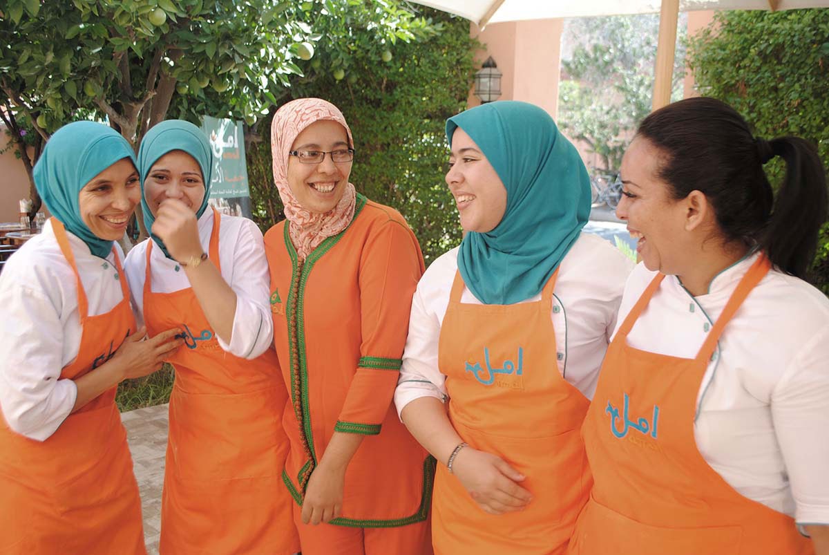 five women laughing in uniform at the Amal Association in Marrakech Morocco